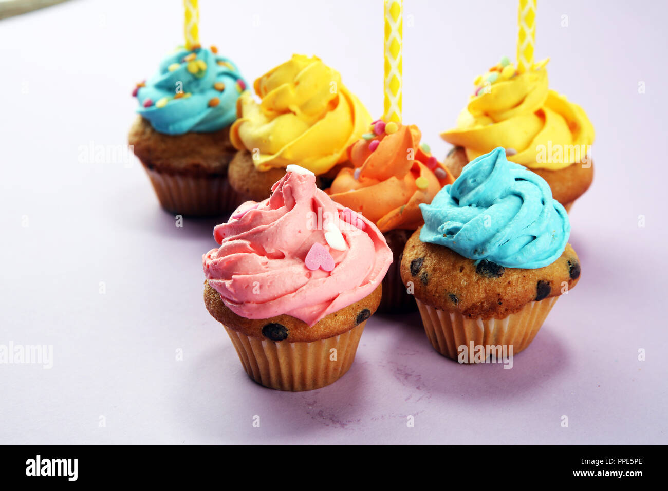 Tasty cupcakes on pinke background. Birthday cupcake in rainbow colors Stock Photo