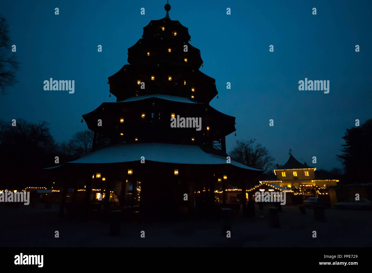 Beautifully lit Christmas market at the Chinese Tower in the English Garden. Stock Photo