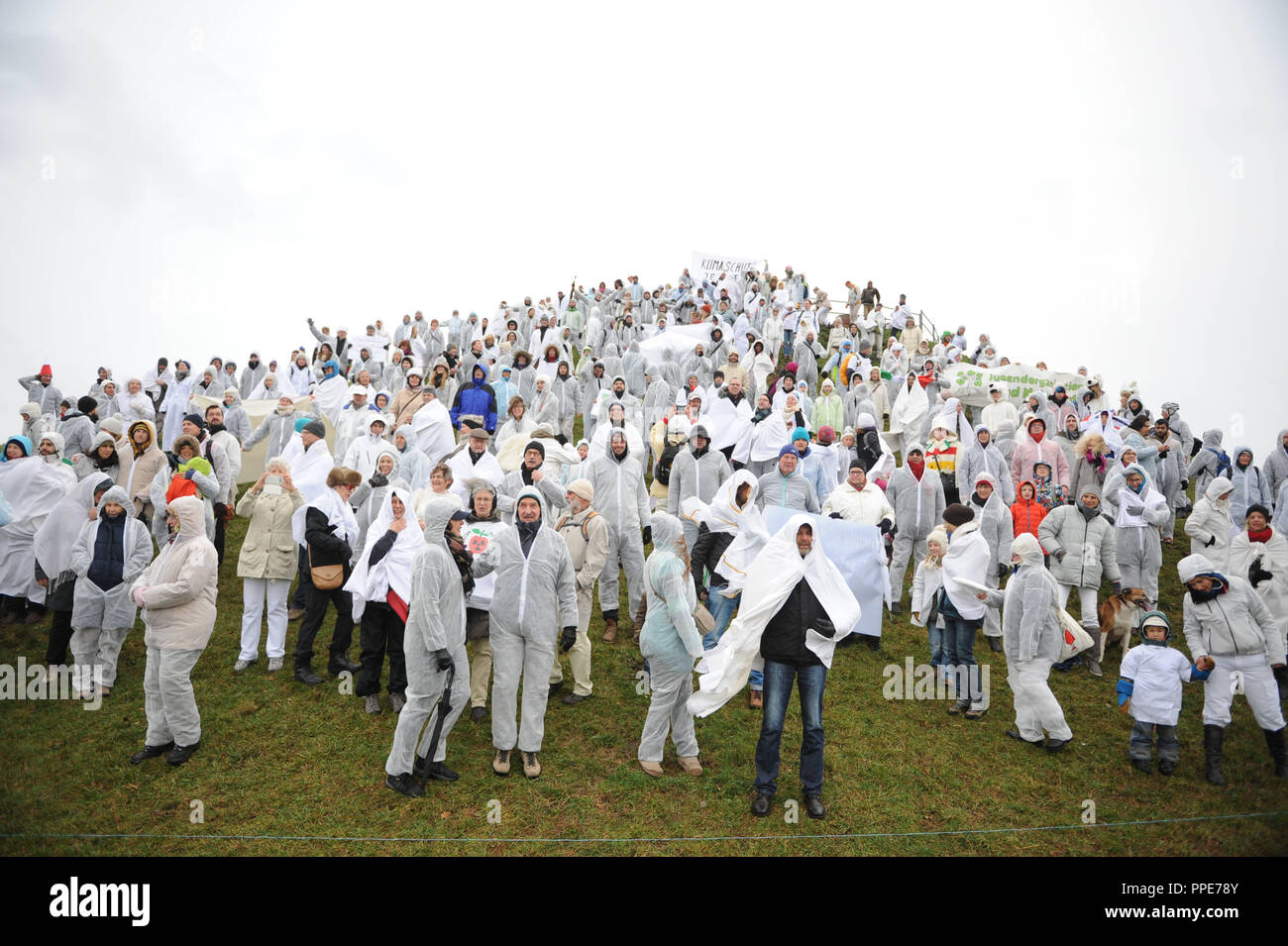 On the occasion of the United Nations Climate Change Conference in Paris, about 300 white men dressed in white transform the peak of the Olympiaberg into a symbolic glacier. The environmental organization 'Green City' is the organizer of the protest campaign for climate protection and a worldwide energy turnaround. Stock Photo