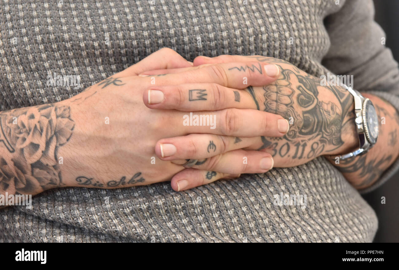 The Berlin-based rapper Sido (aka Paul Wuerdig) opened his tattoo studio  "Meine Katze und ich" at Kapuzinerstrasse 35 in Isarvorstadt. In the  picture, the tattooed arms of the musician Stock Photo -