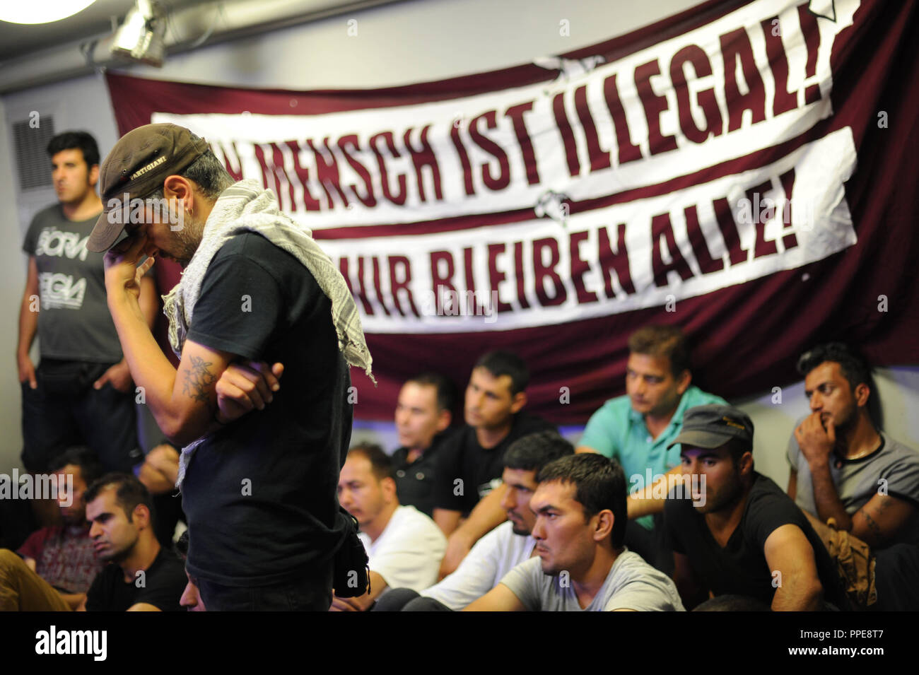 Matthias Jena (not in the picture), the Chairman of the Confederation of German Trade Unions (DGB) Bavaria, presents a compromise offer to the asylum seekers in the Munich DGB headquarters to withdraw from the premises in the Schwanthalerstrasse, where they had been temporarily  accommodated following a protest march through Bavaria. Stock Photo
