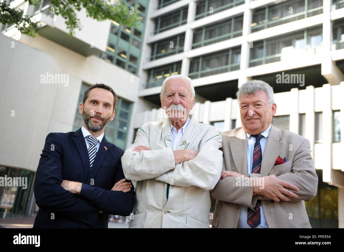 The court interpreters Roberts Putnis, Bogoslav Petan and Martin Waniek (left to right), pictured before the Criminal Justice Center at the Nymphenburgerstrasse 16. Stock Photo