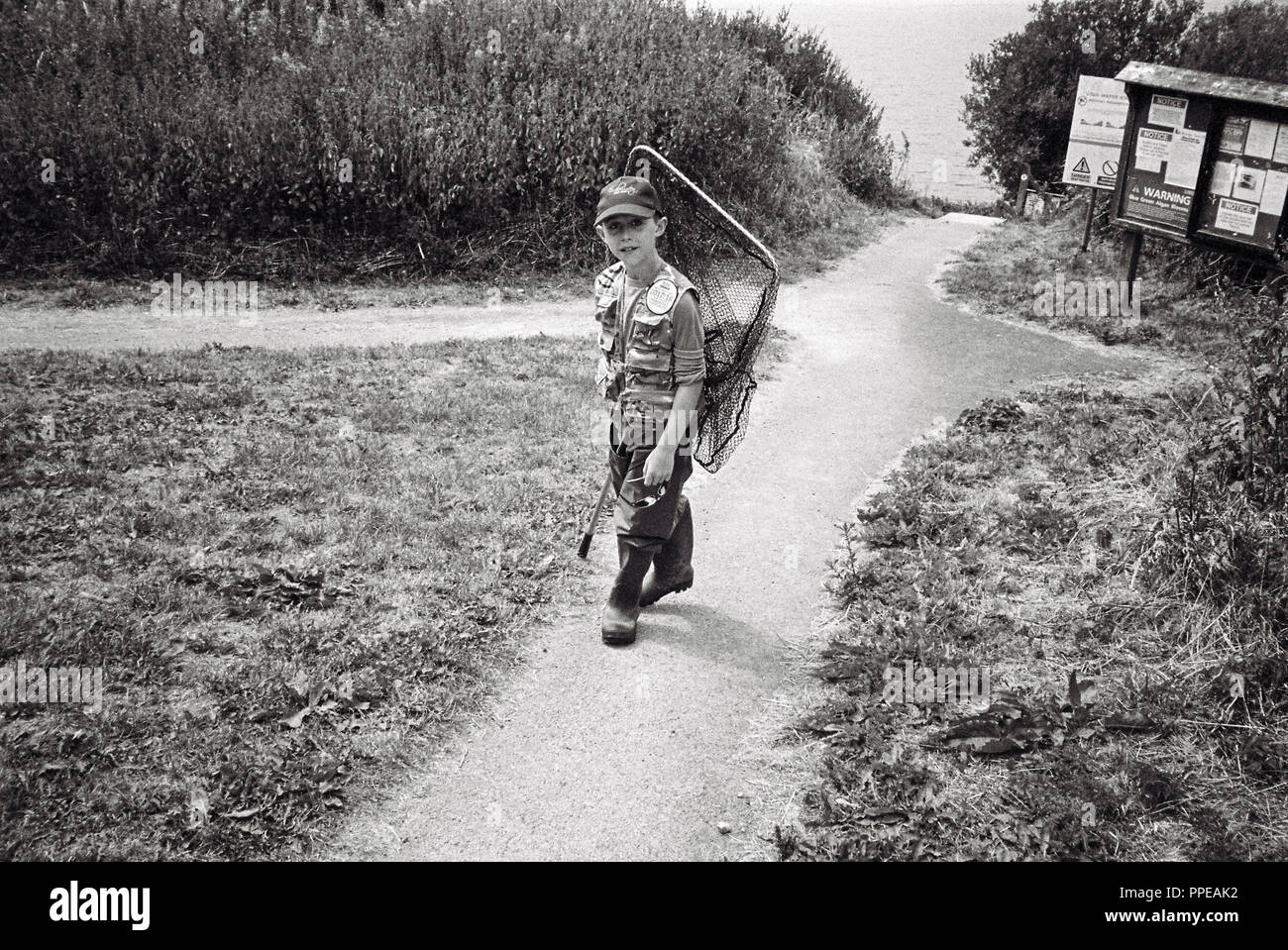 Nine year old boy fly fishing at Scout Dike Reservoir, Thurlstone