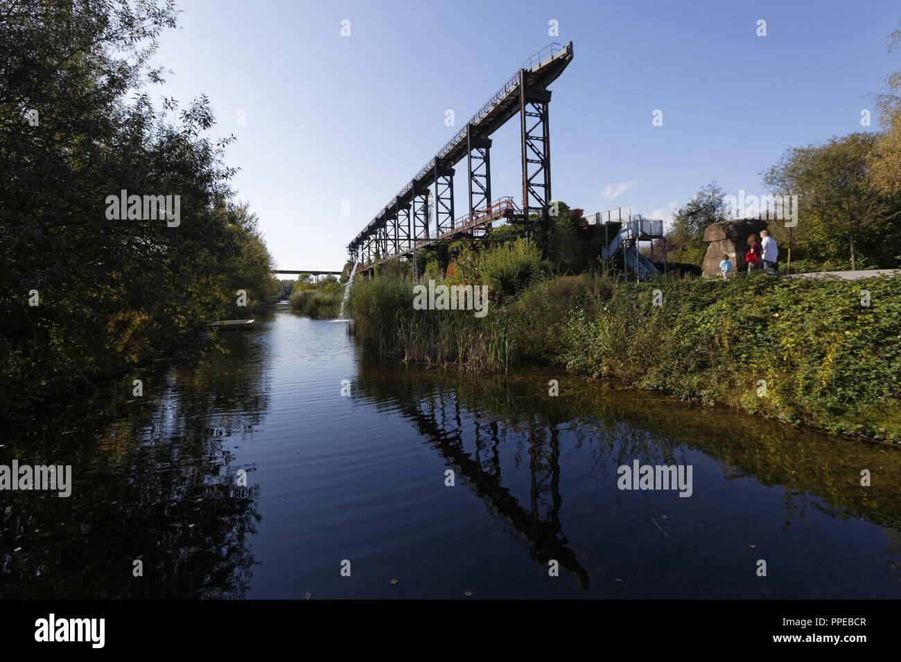 Transformation of a former ironworks and an industrial fallow to the Landscape Park Duisburg-Nord, a public park and an industrial monument, New Old Emscher and crane track | usage worldwide Stock Photo