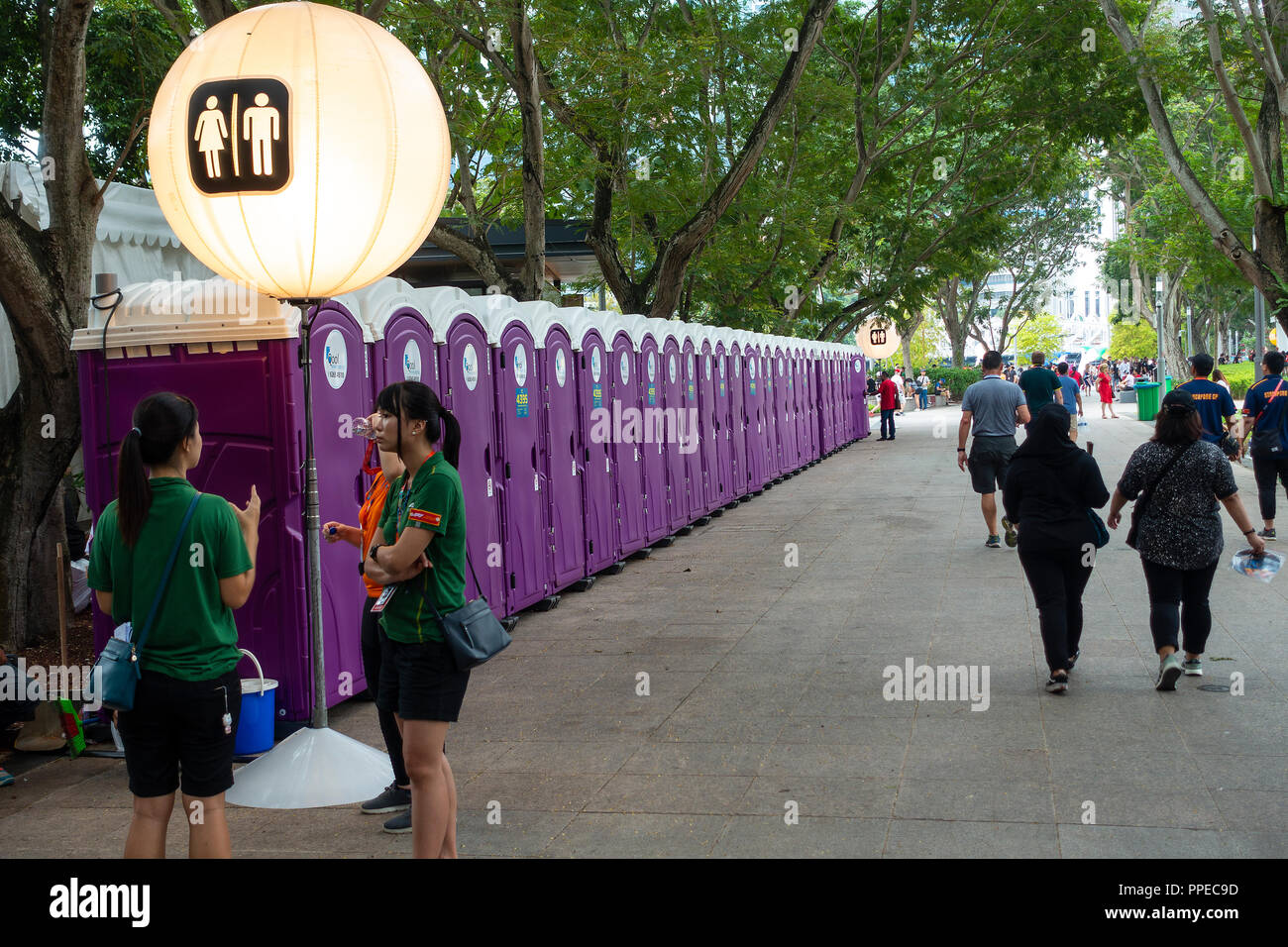 A Long Row of Purple Ladies and Gents Toilets for Public Use at the Formula One Singapore Grand Prix Motor Racing Event in Singapore Asia Stock Photo