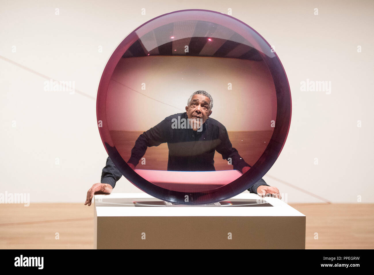 Artist Fred Eversley with 'Untitled (Parabolic Lens) 1971', made of cast polyster resin, during a press preview for the exhibition: Space Shifters at the Hayward Gallery, Southbank Centre, London. Stock Photo
