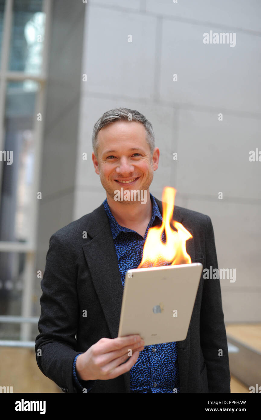Magician Simon Pierro performs magic tricks with his iPad Stock Photo