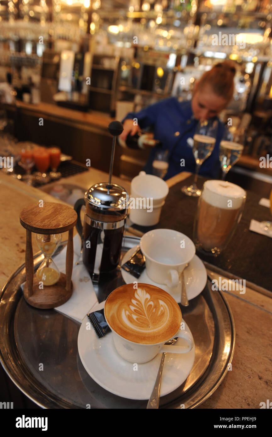 Preparation of a milk coffee at the Munich coffee house Dallmayr. Stock Photo