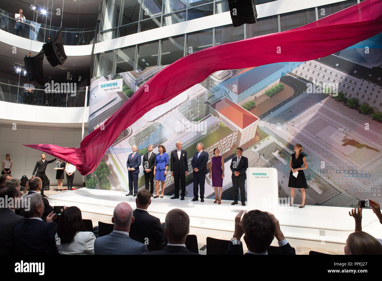 The red tape ahead of Siemens CEO Joe Kaeser, Minister of Economic Affairs Ilse Aigner, Chairman Gerhard Cromme and Munich's Lord Mayor Dieter Reiter at the opening of the Siemens headquarters at Wittelsbacher Platz in Munich. Stock Photo