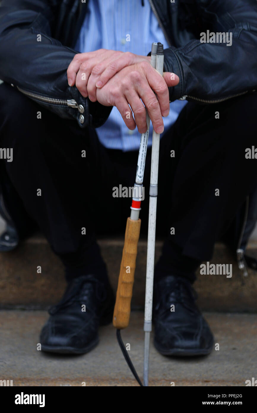 Visually impaired person with white cane in Munich Stock Photo Alamy