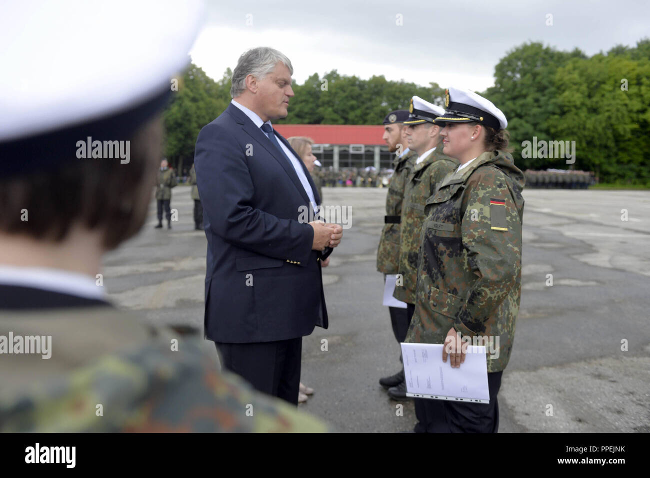 Officials of the Bundeswehr during the solemn roll call on the Open Door Day at the University of the Bundeswehr in Neubiberg. In the picture, Markus Gruebel, Parliamentary State Secretary at the Federal Ministry of Defence, congratulates soldiers on their promotion. Stock Photo