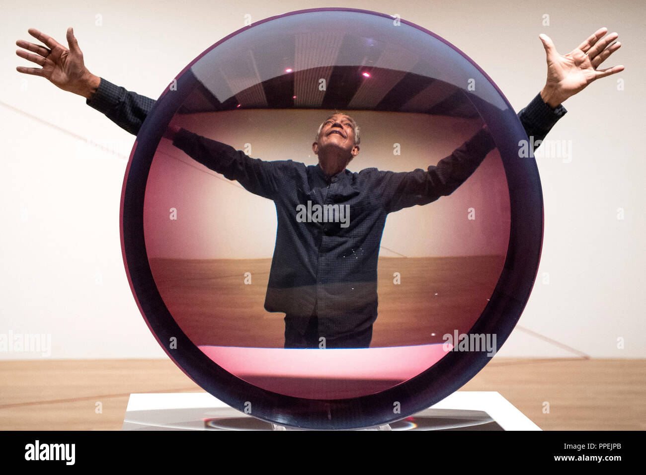 Artist Fred Eversley with 'Untitled (Parabolic Lens) 1971', made of cast polyster resin, during a press preview for the exhibition: Space Shifters at the Hayward Gallery, Southbank Centre, London. Stock Photo