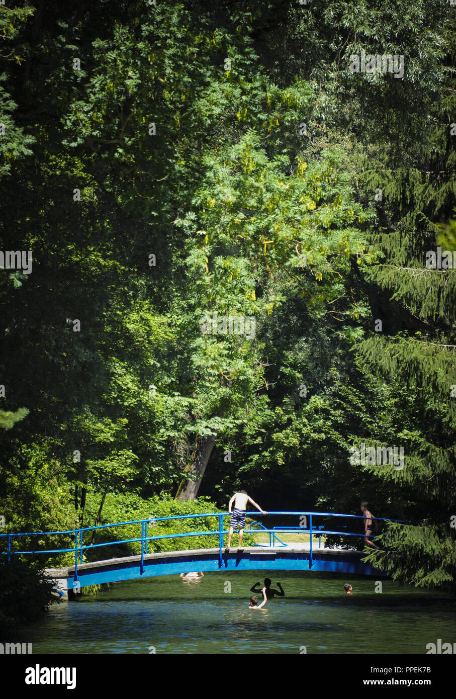 A bridge over the Isarkanal in the outdoor swimming pool "Maria Einsiedel" in Munich. Stock Photo