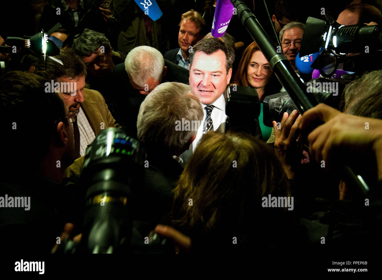 The 2014 local elections in Munich: Joseph Schmidt (middle), mayoral candidate of the CSU is surrounded by representatives of the media on the election night in the office of the District Administration Authority in the Poccistrasse. Behind him, his wife Natalie. Stock Photo