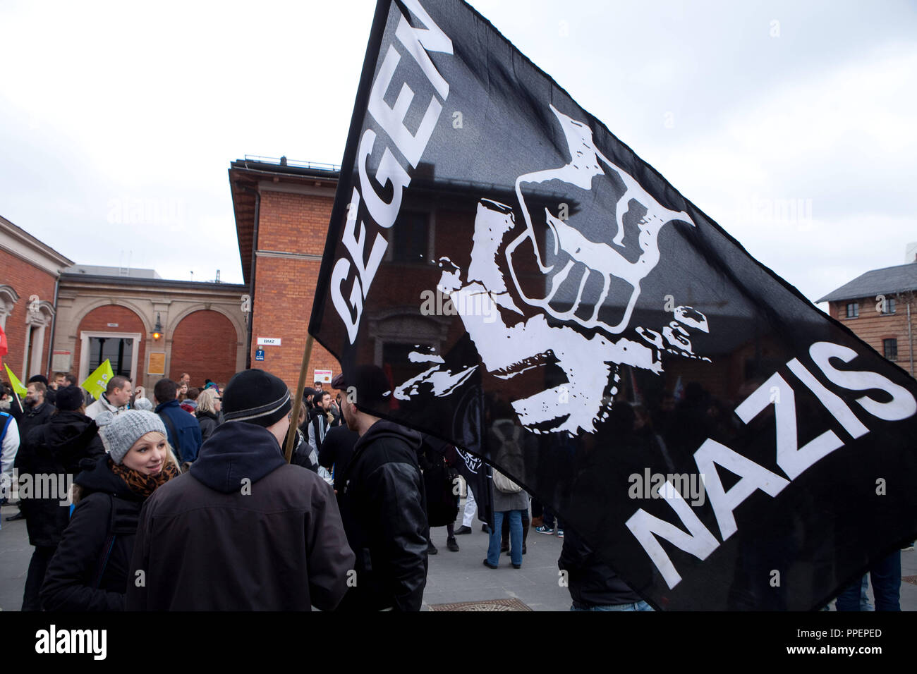 The alliance against Nazi terror and racism has called for a demonstration against the neonazi-residential community in the Carl-Hanser-Straße in Obermenzing. 'Against Nazis' is written on the flag at the Bahnhofsvorplatz in Munich, Germany Stock Photo