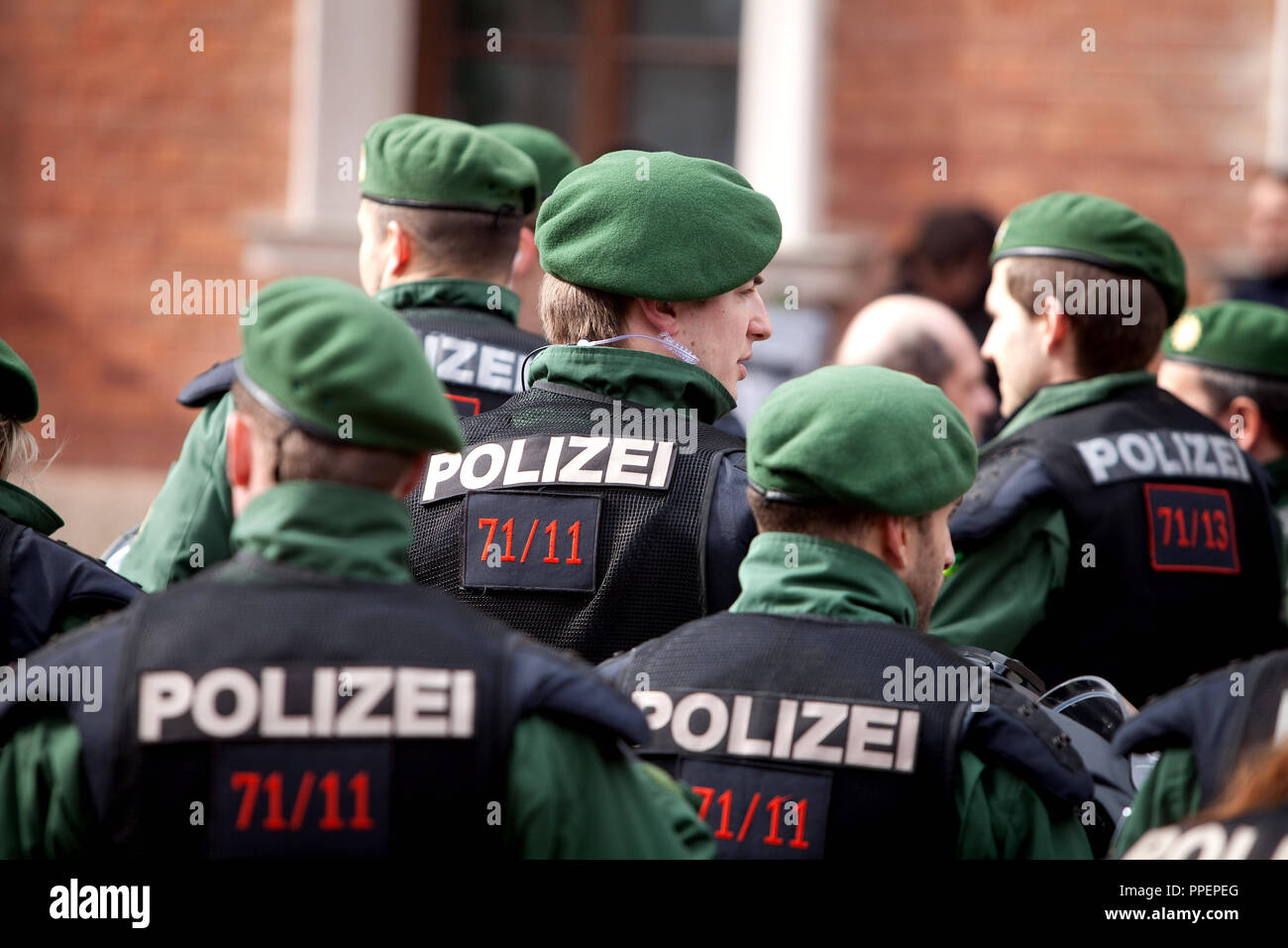 The alliance against Nazi terror and racism has called for a demonstration against the neonazi-residential community in the Carl-Hanser-Straße in Obermenzing. Back view of police officers in the Bahnhofsvorplatz in Munich, Germany Stock Photo