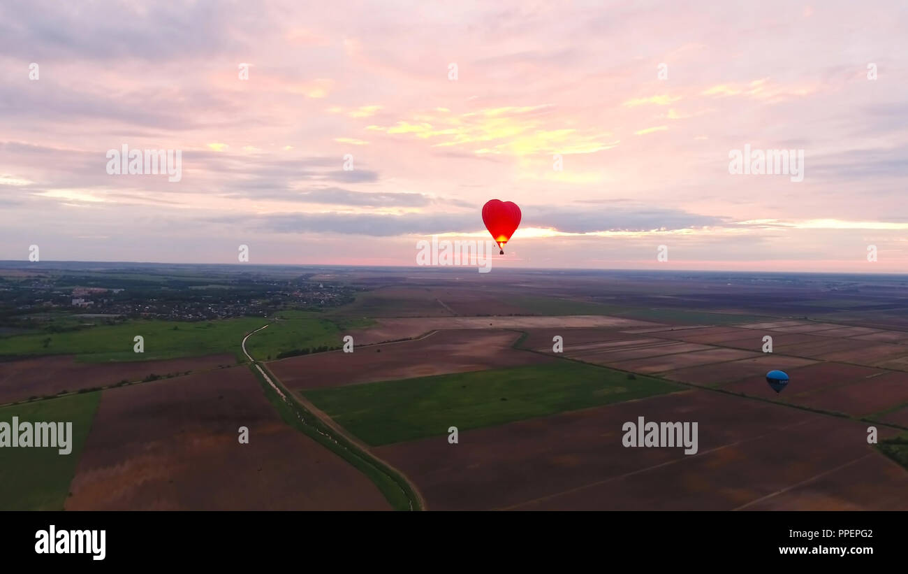 Hot air balloon shape of a heart in the blue sky. Aerostat, Airship ...