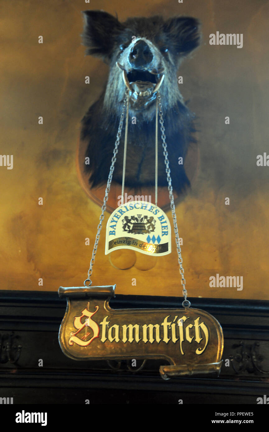 Boar's head with Stammtisch (regulars' table) sign in the Augustiner restaurant 'Isarthor' in the Kanalstrasse 2. Stock Photo