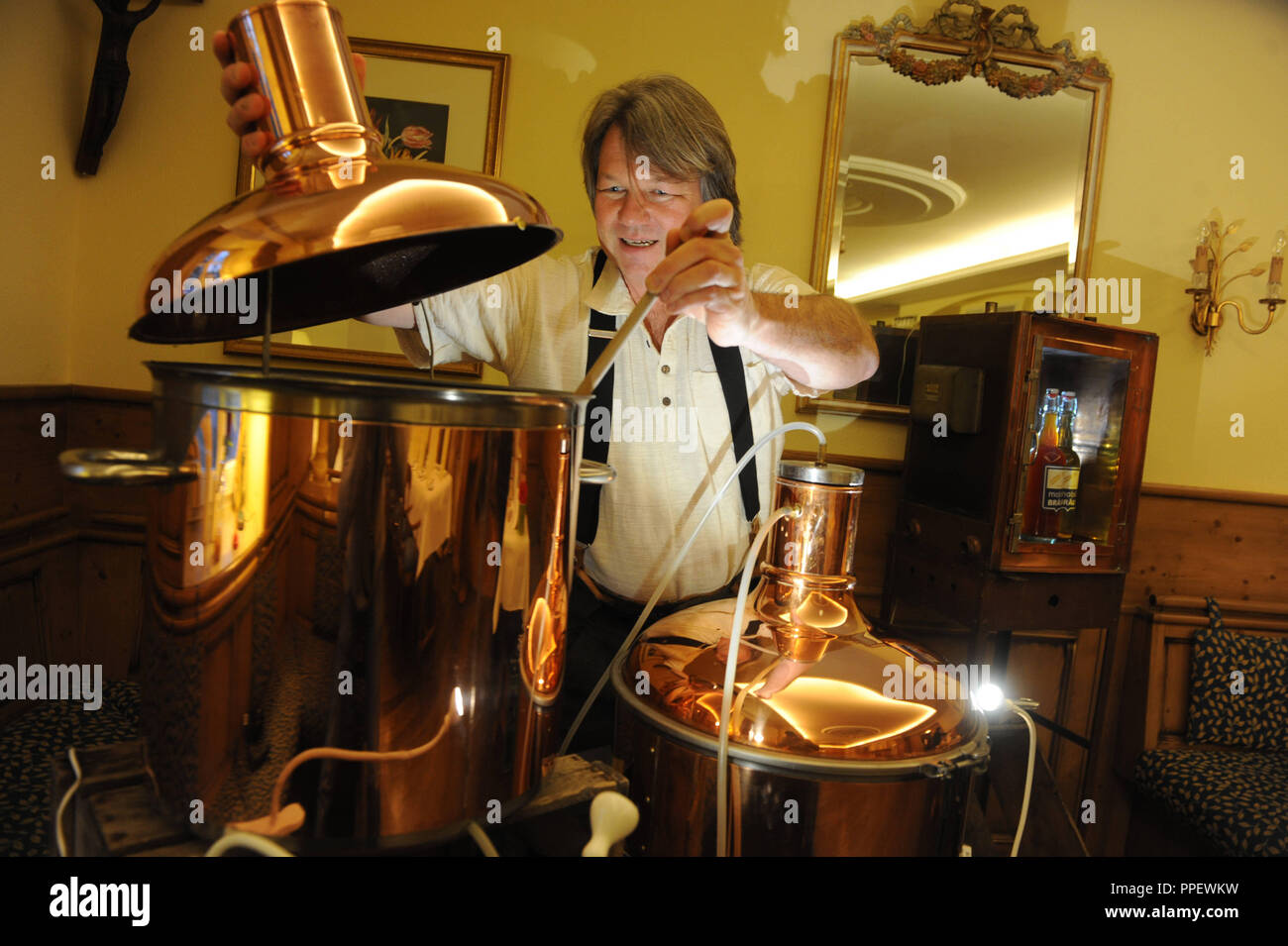 The trained brewmaster Jakob Stefan, founder of the 'Mobil Braeu' service, offers on-site brewing courses to companies with its mobile brew kettle. Stock Photo