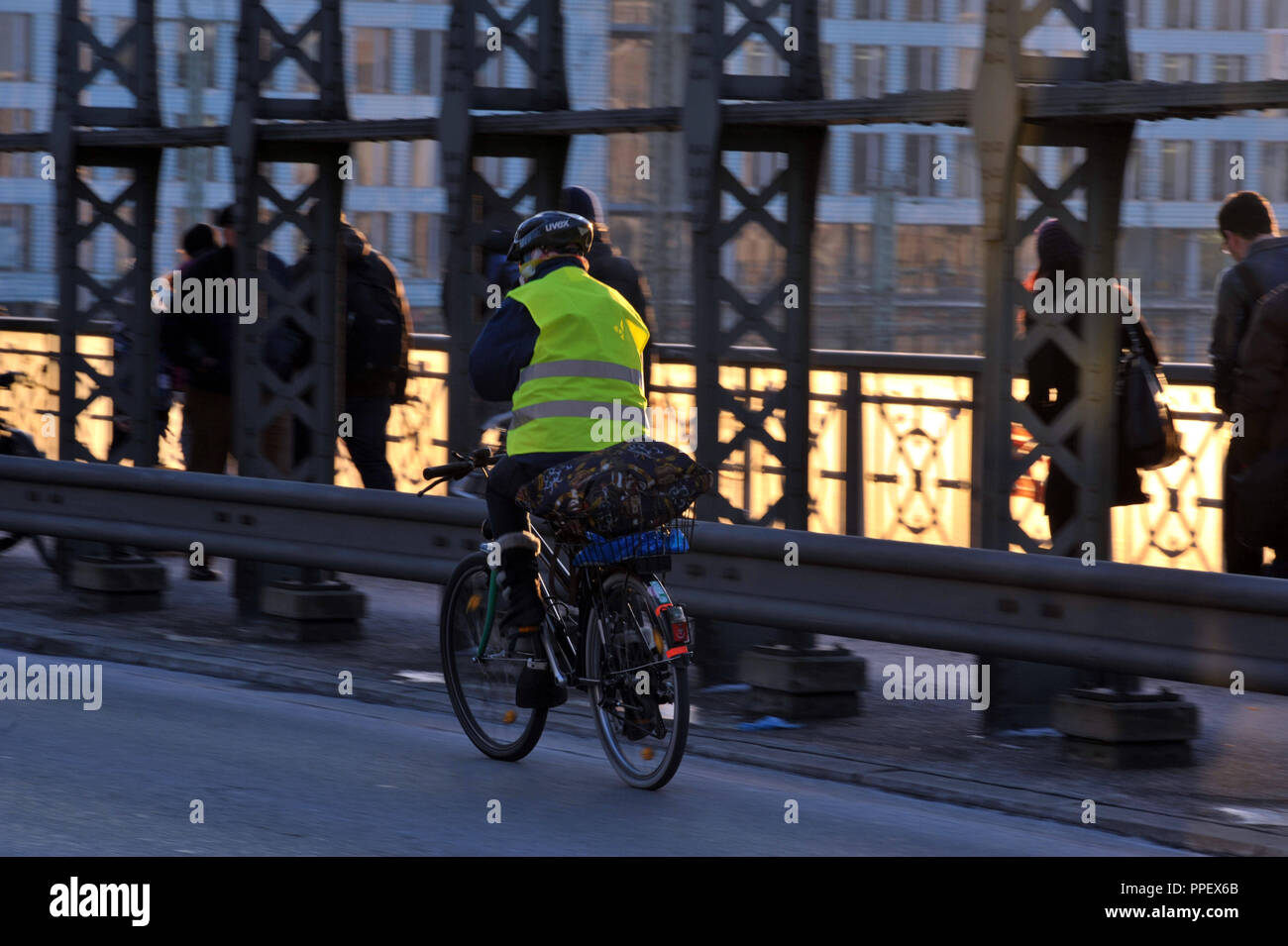 Cyclist and pedestrians in the early morning on the Hackerbrucke in Munich. Stock Photo