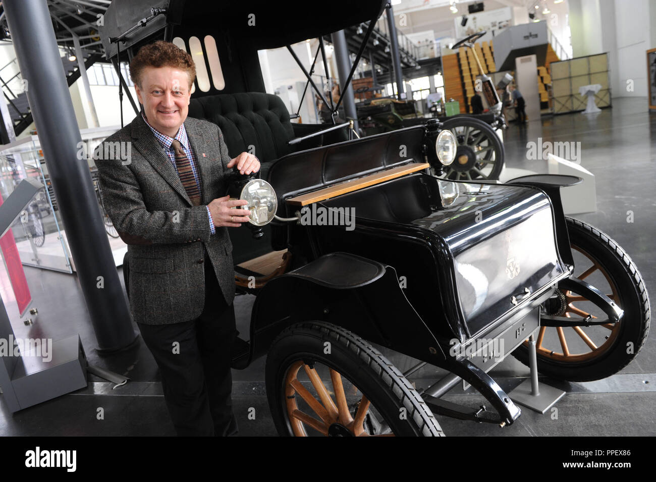 Professor Dr. Wolfgang M. Heckl, Director General of the Deutsches Museum in Munich, with an electric car from the year 1908. The historic electric vehicle can be seen in the exhibition 'Elektromobilitaet' (Electric mobility) in the Deutsches Museum Verkehrszentrum (Museum of Transport) on the Theresienhoehe. Stock Photo