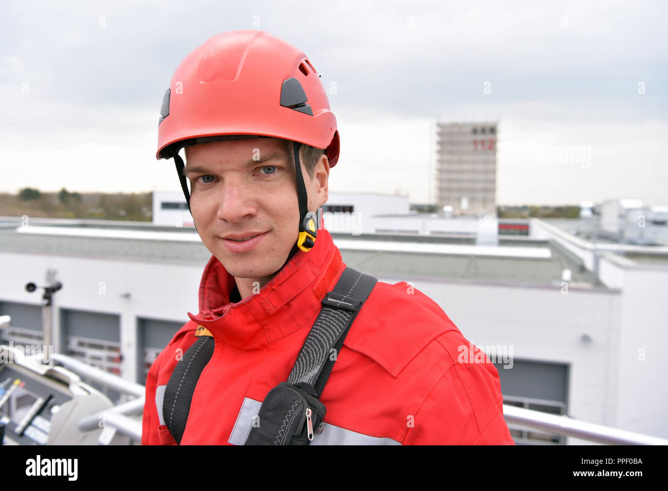 training in altitude rescue at the fire brigade - emergency operation with a crane trolley and abseiling Stock Photo