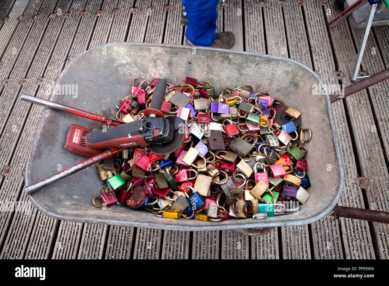 An employee of the municipal building directorate removes padlocks with