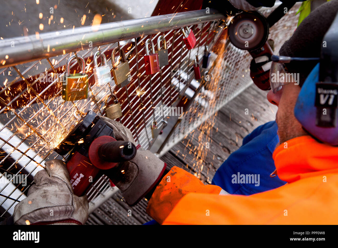 An employee of the municipal building directorate removes padlocks with