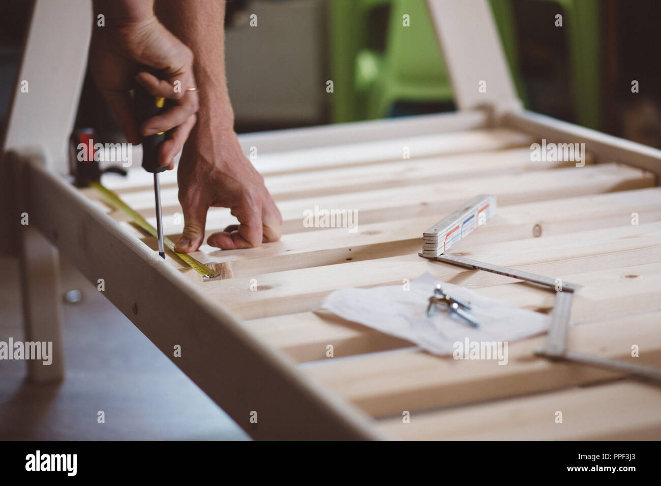 close up hands of a man, a man screws a screwdriver, instruction and construction roulette, self-Assembly of furniture Stock Photo