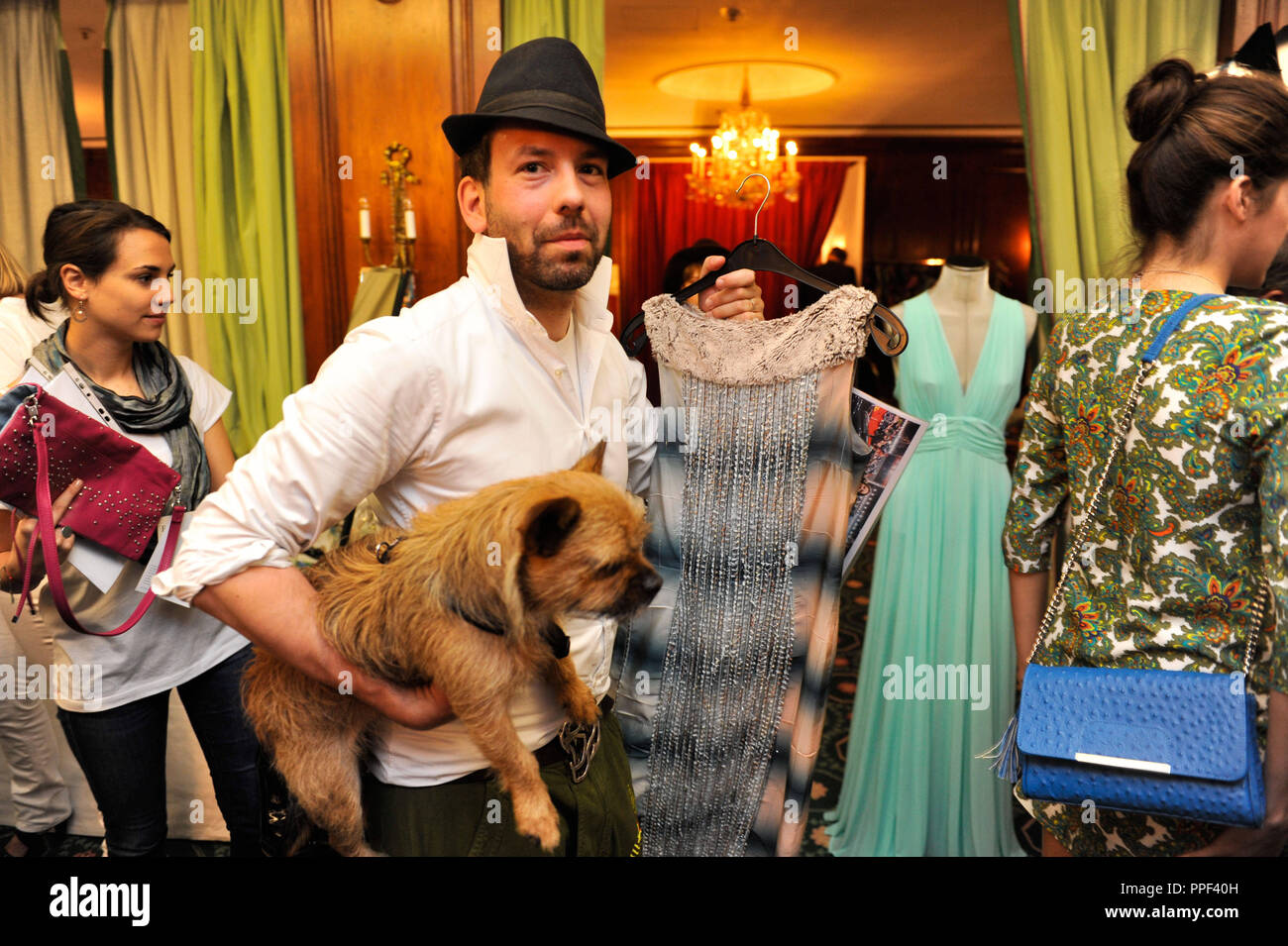 Fashion designer Kay Rainer with dog Emmi at the 'Buy My Dress' charity sale of dresses and accessories of celebrities at Hotel Bayerischer Hof in Munich in favor of the children's aid organization 'Children for a better World e.V.'. Stock Photo