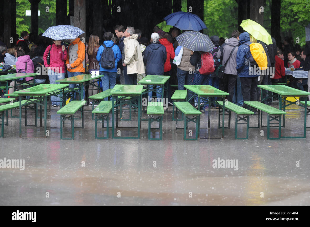Visitors seek shelter from the heavy rain at the Chinese Tower. Stock Photo