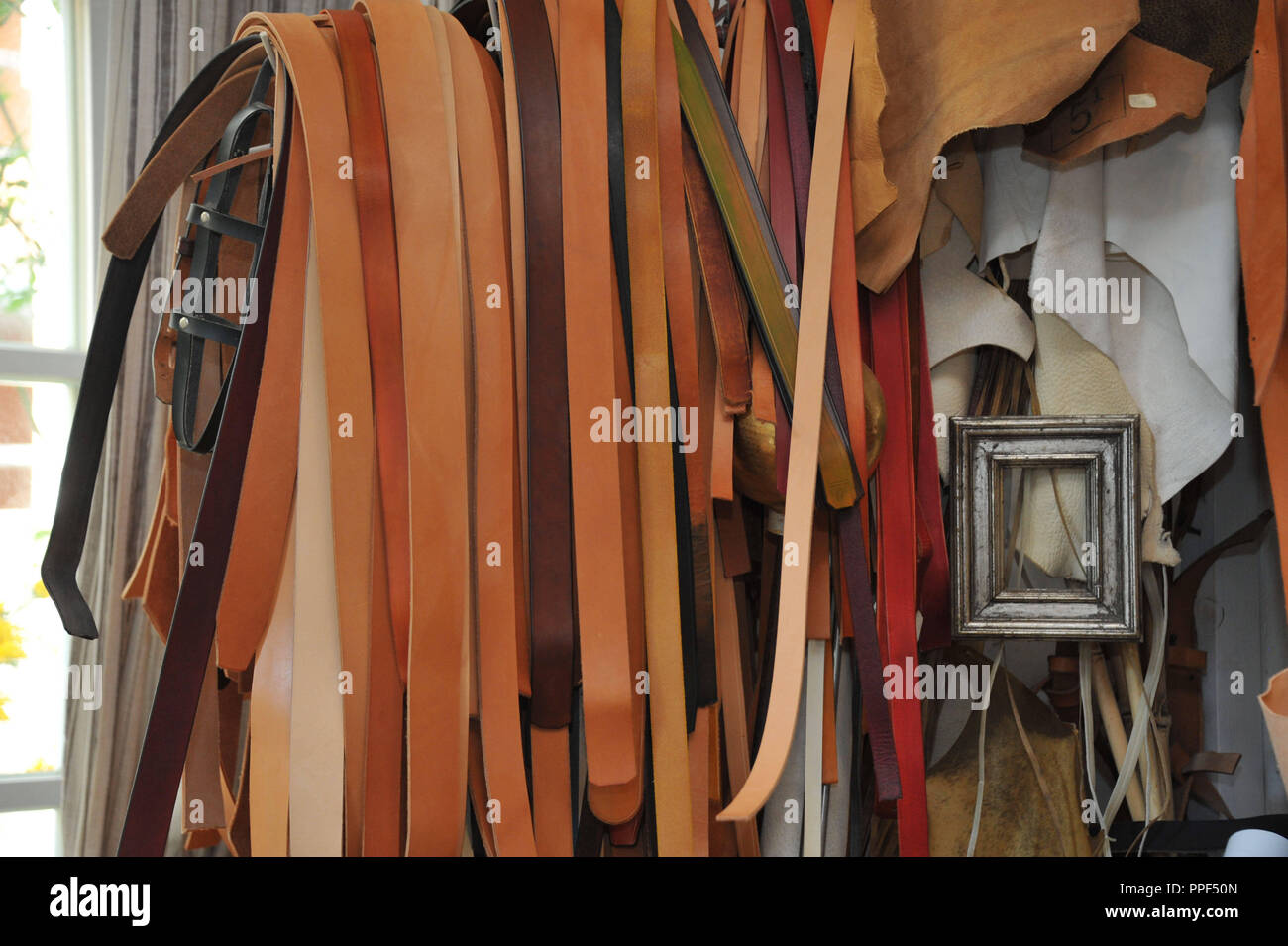 Leather straps of various length for manufacturing of handbags in the studio of Bettina von Reiswitz. Stock Photo