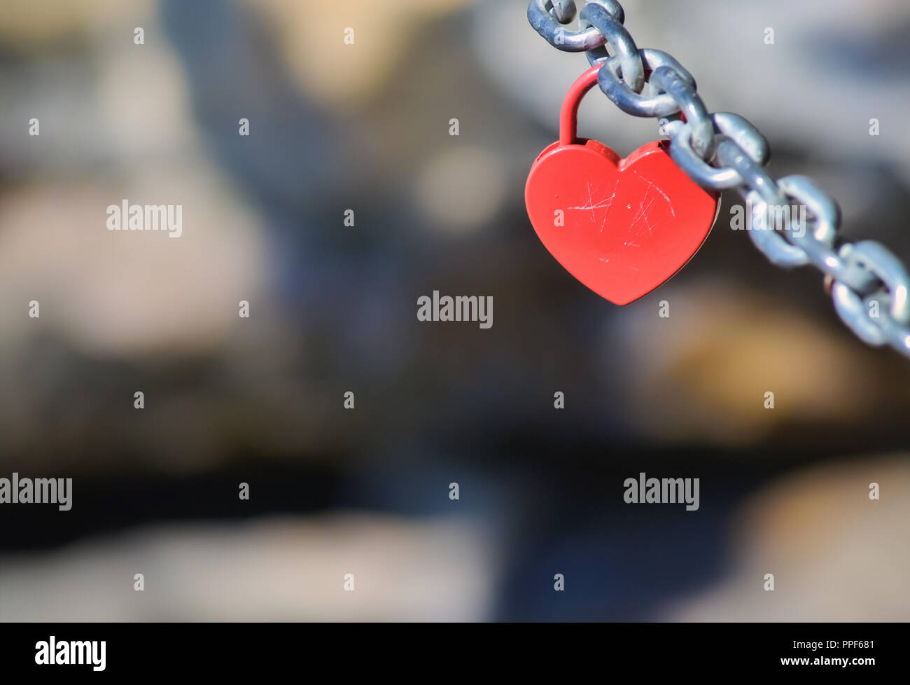 Red padlock in shape of heart hanging on a chain Stock Photo - Alamy