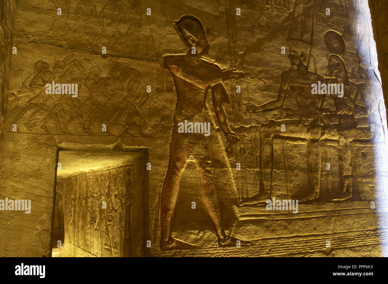 Egyptian art. Great Temple of Ramses II. The pharaoh Ramses II before god Amun.19th Dynasty. New Kingdom. Stock Photo