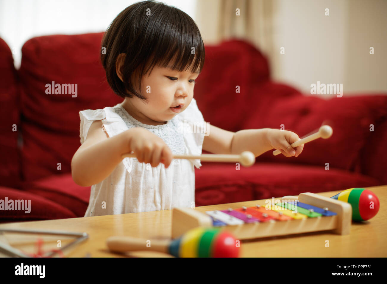 baby girl play xylophone at home Stock Photo Alamy