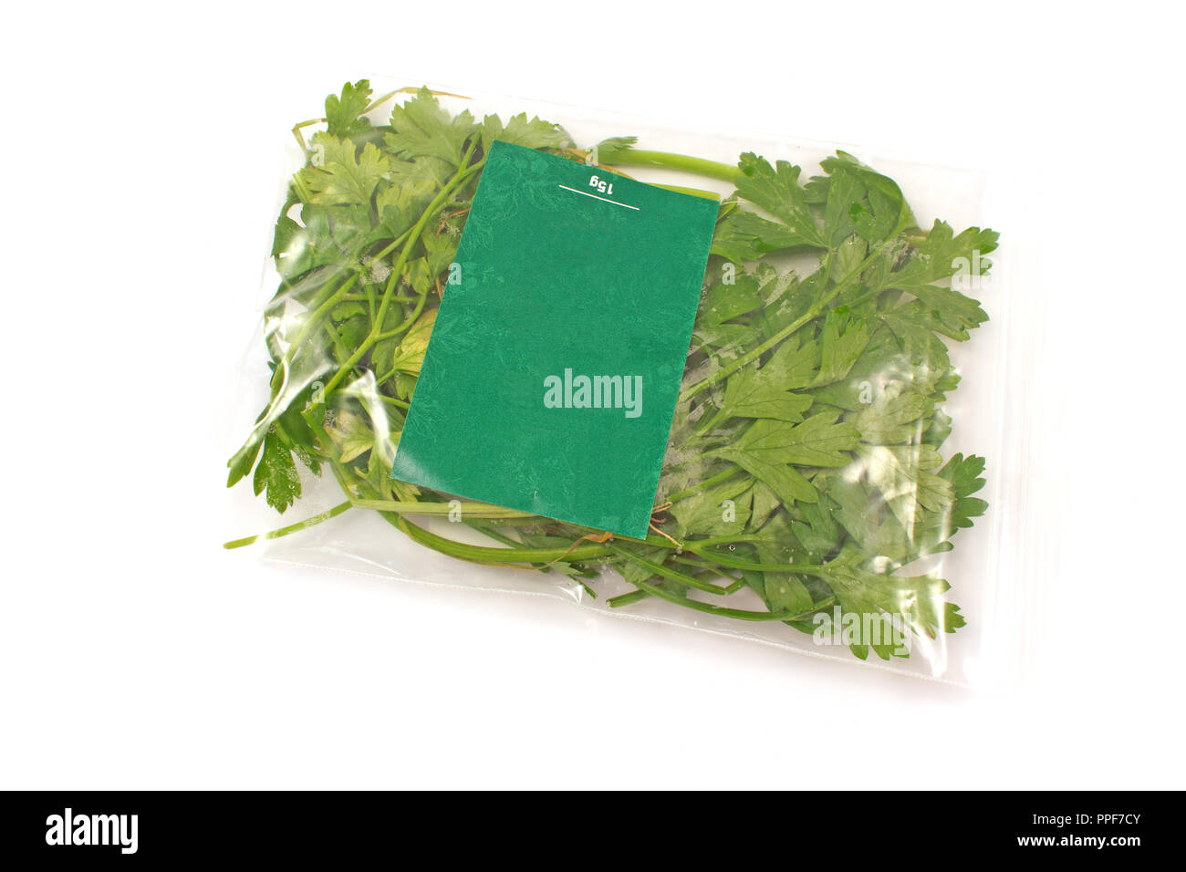 Parsley leaves packed in plastic bag isolated on white Stock Photo Alamy