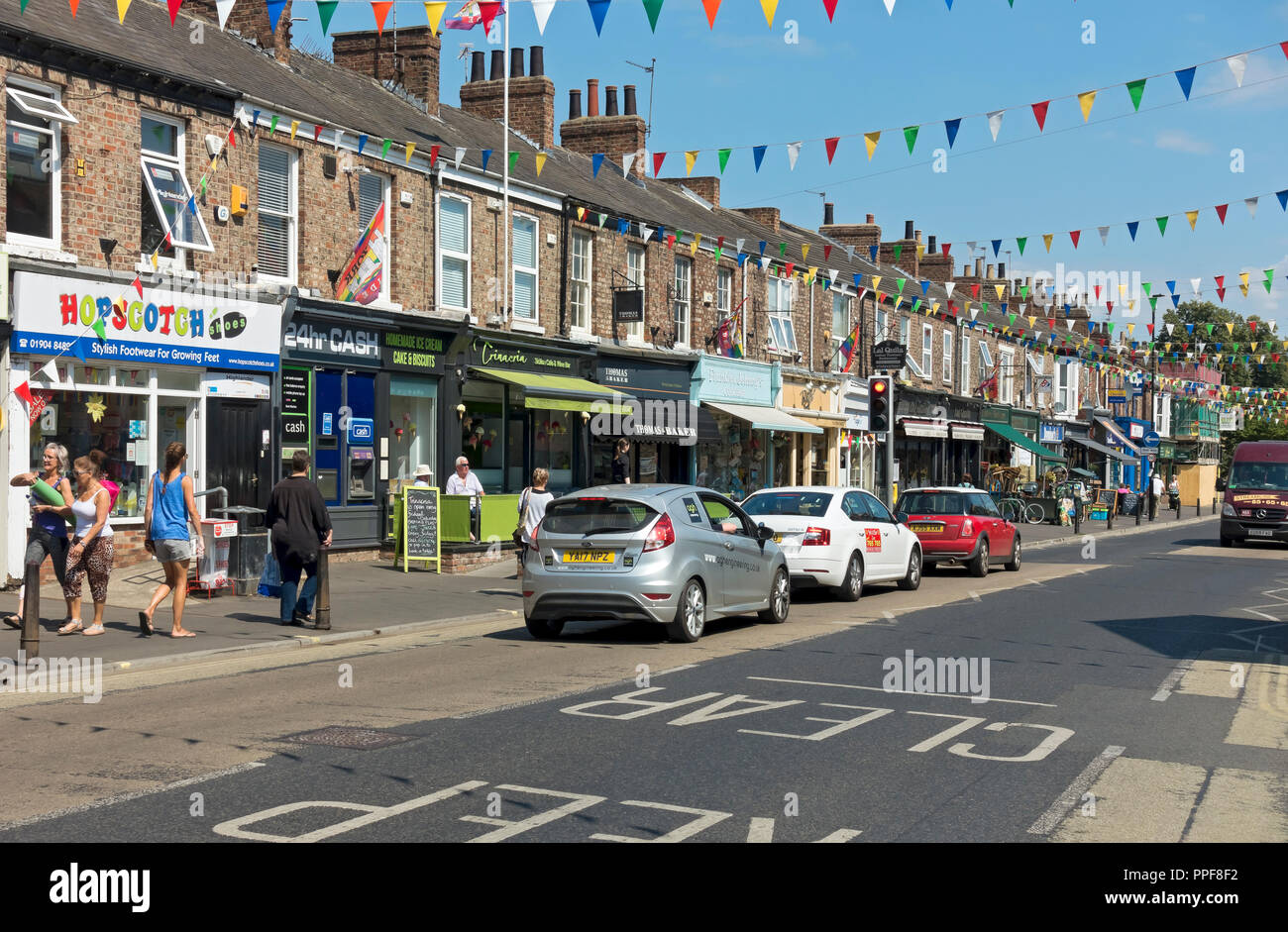 Shops stores businesses on Bishopthorpe Road in summer (also known as Bishy Road) York North Yorkshire England UK United Kingdom GB Great Britain Stock Photo