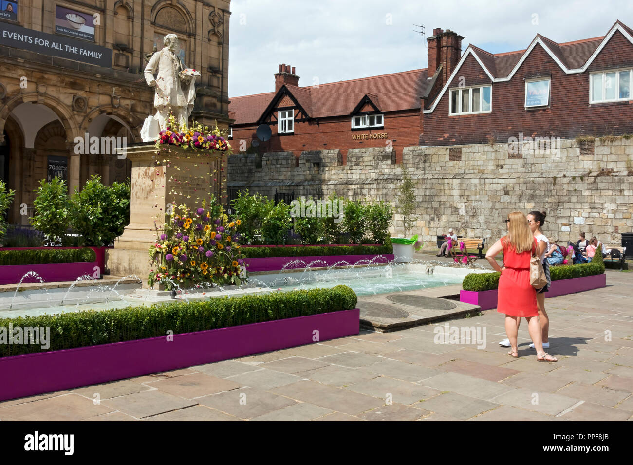 William Etty statue decorated with flowers for the Bloom Festival in summer Exhibition Square York North Yorkshire England UK United Kingdom Britain Stock Photo