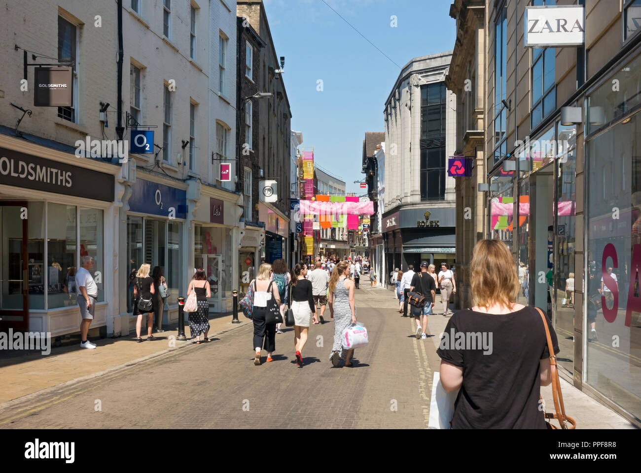 People shopping shoppers in the city town centre shops stores in summer Spurriergate York North Yorkshire England UK United Kingdom GB Great Britain Stock Photo