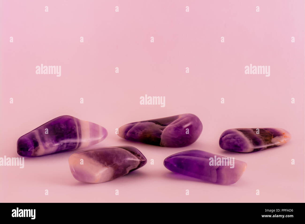 Polished dogtooth amethyst stones background with copy space Stock Photo