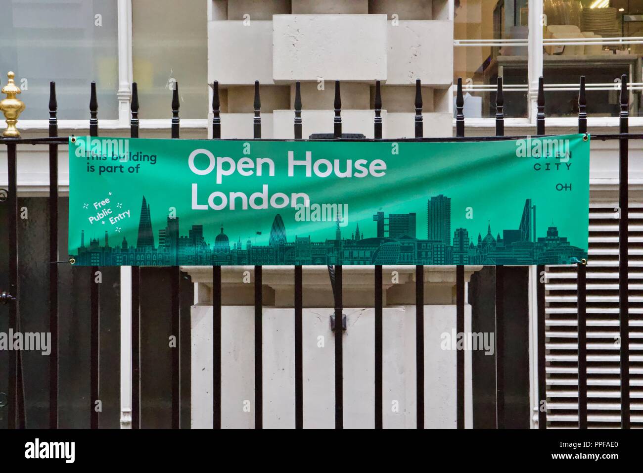 A green banner attached to black railings for Open House London 2018, which offers free public entry to over 800 buildings for 1 weekend Stock Photo