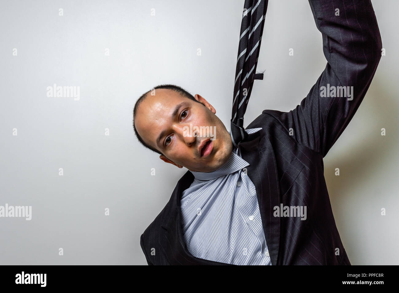 Man hanging himself with the tie Stock Photo - Alamy