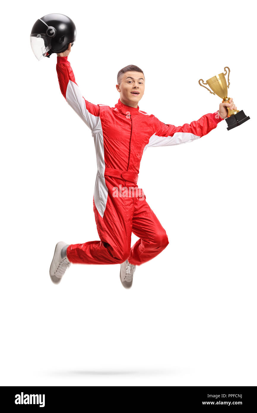 Ecstatic young racer with a gold trophy cup jumping isolated on white background Stock Photo