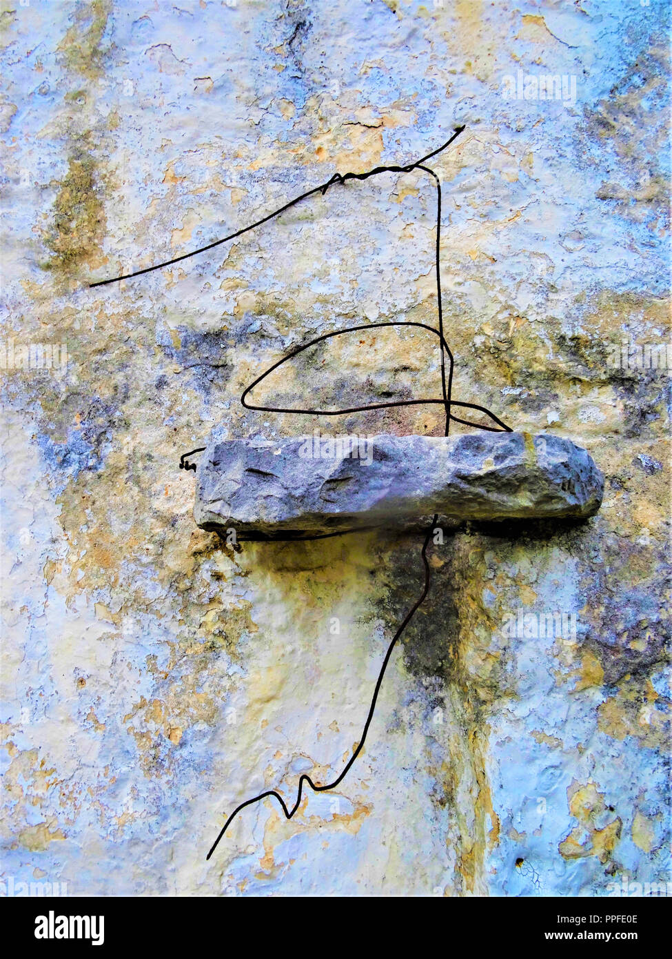 Old dirty wall with lichen and wire frame Stock Photo