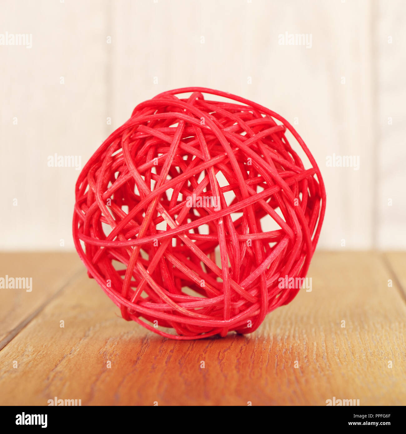 red rattan ball lying on wooden background Stock Photo Alamy