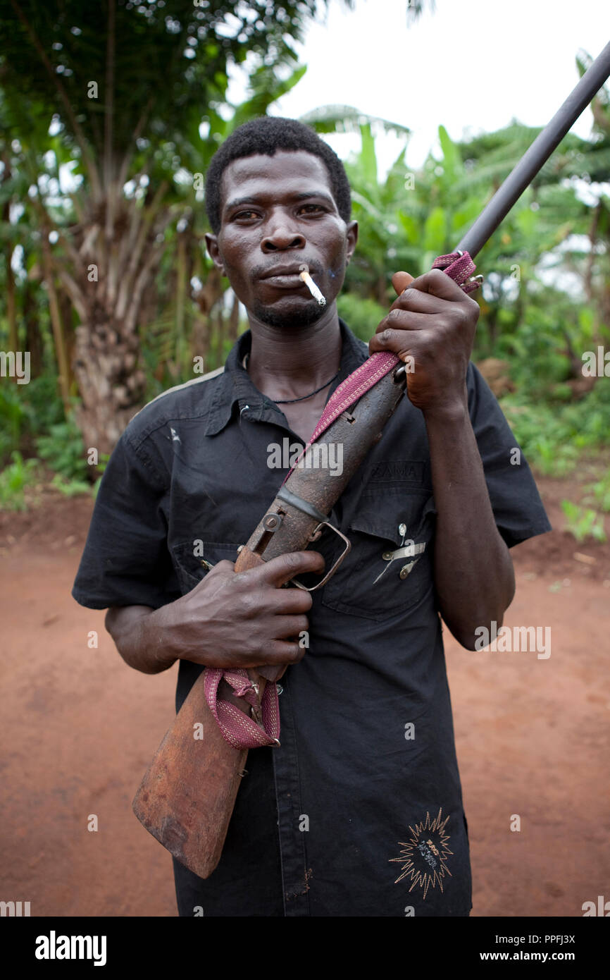10 May 2010 - Yambio, Western equatoria State, South Sudan - Arrow Boy patrolling with home made gun. Western Equatoria State has suffered years of attacks by the Lord’s Resistance Army. Thousands of civilians have been displaced and hundreds killed or abducted in the border area between Southern sudan, DRC and the Central African Republic. In the absence of an effective response by the Sudanese government to the Lord’s Resistance Army, many local men and boys have organized self-defense forces known as the Arrow Boys who battle the relatively well-armed LRA with traditional weapons such as bo Stock Photo