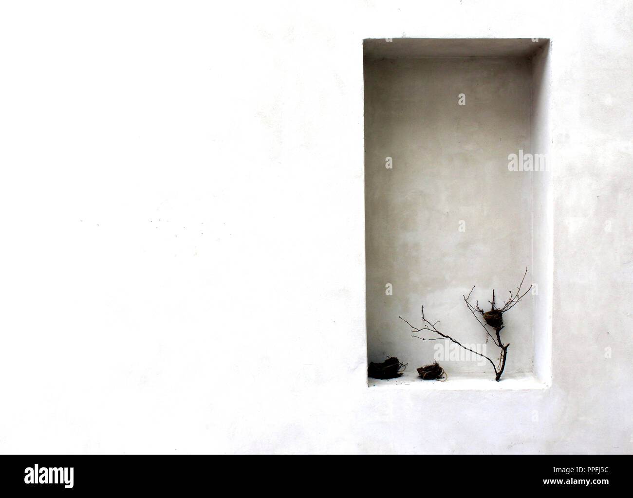 Walled concrete window with seen in detail with still life objects Stock Photo