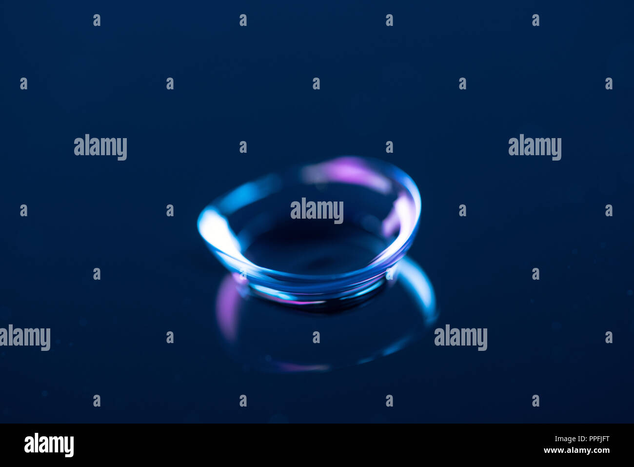 close up view of contact lense on blue backdrop Stock Photo