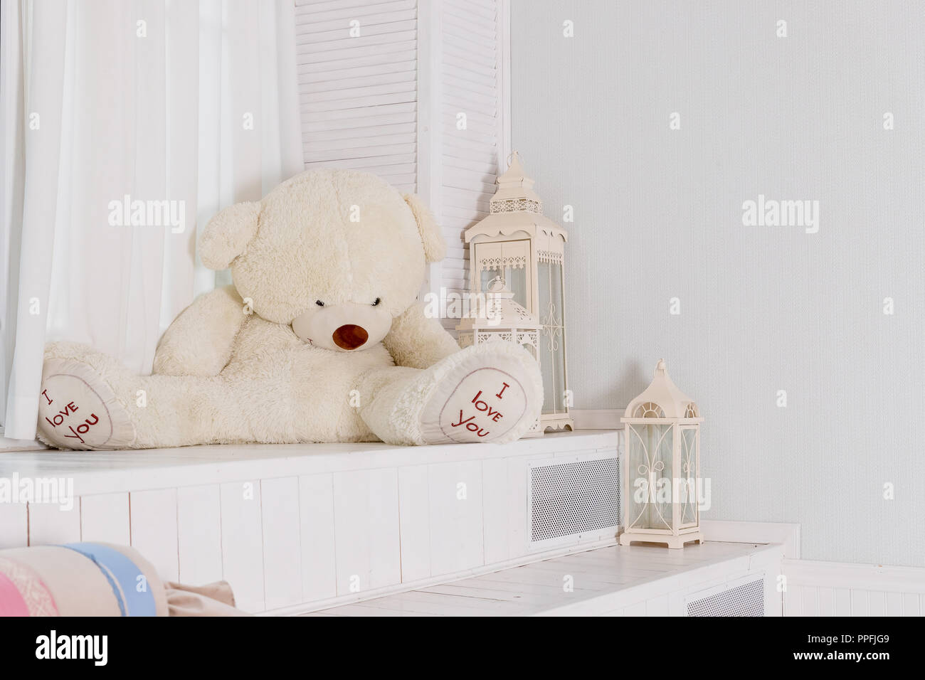 Big teddy bear near big white lantern,pillows in girly room ...