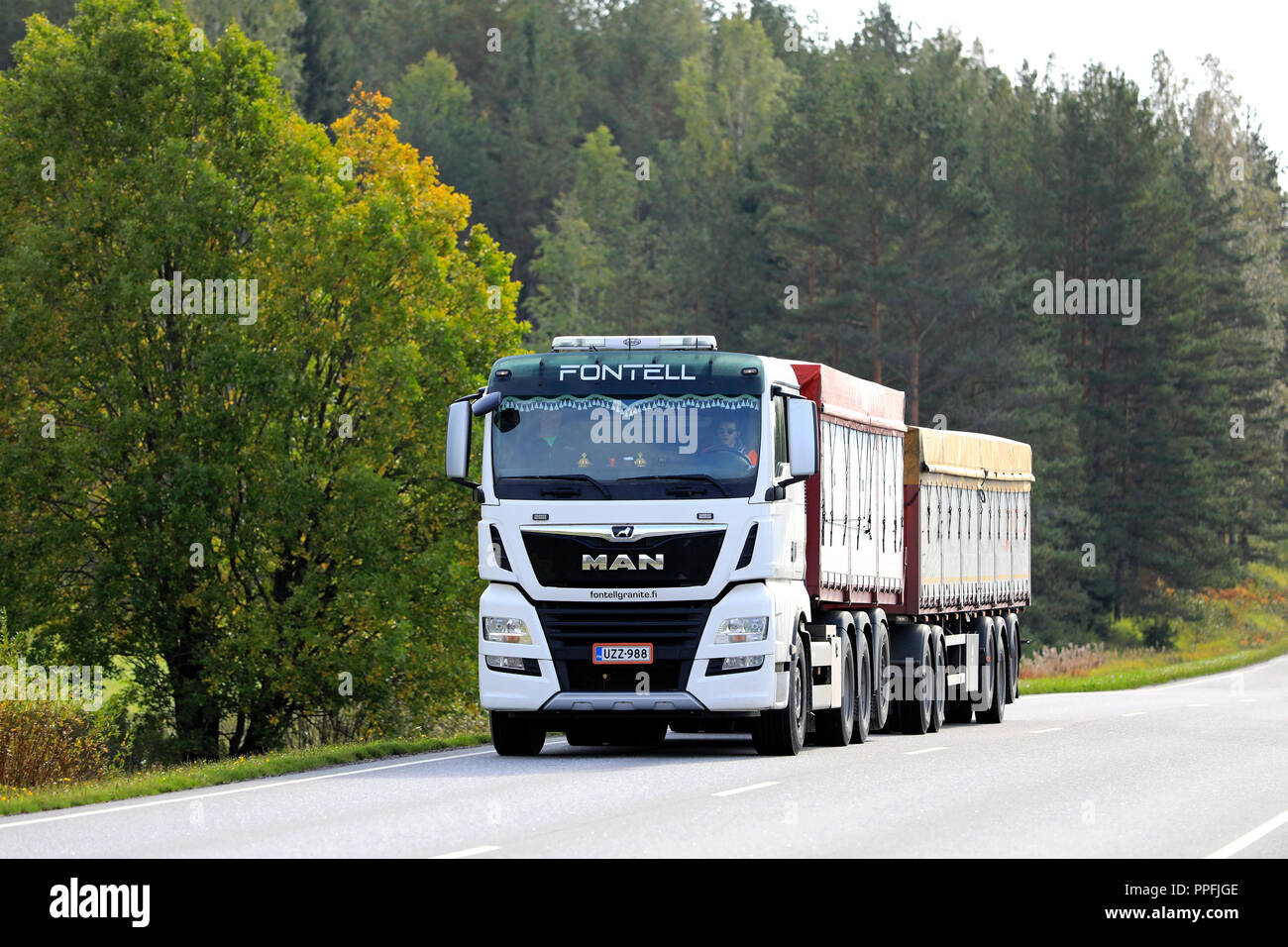 Salo, Finland - September 21, 2018: New, white MAN TGX 35.580 cargo truck of Fontell Granite Ltd on rural highway in autumn. Stock Photo